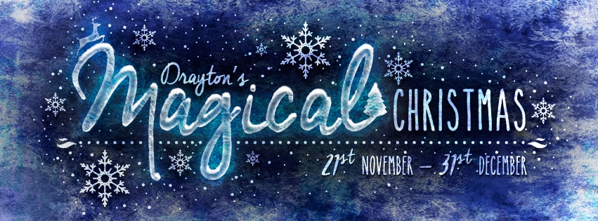 Text reads "Drayton’s Magical Christmas 27th November – 31st December" in white, whimsical font on a blue, snowy background with snowflakes and a Christmas tree forming the "i" in "Magical." The design feels festive and wintry.