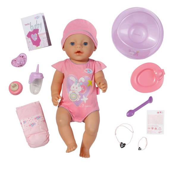 A baby doll wearing a pink onesie and hat is displayed with accessories: a bottle, dummy, nappy, bib, bowl, spoon, plate, two bracelets, booklet, and instruction sheet, all mostly in pink and purple, arranged neatly on a white background.