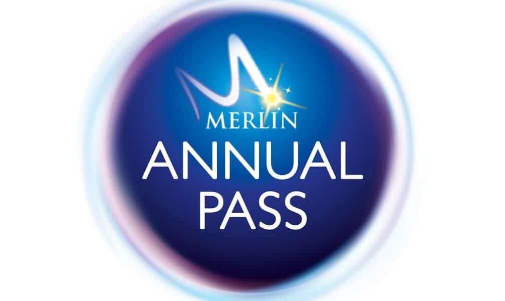 A circular blue logo with a glowing border. In the centre, white text reads "MERLIN ANNUAL PASS," with a stylised "M" and a yellow star above the word "MERLIN." The background fades from dark blue to lighter blue at the edges.