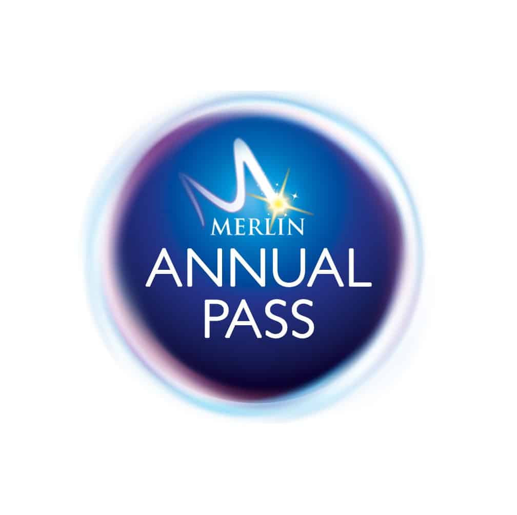 A circular blue logo with a glowing border. In the centre, white text reads "MERLIN ANNUAL PASS," with a stylised "M" and a yellow star above the word "MERLIN." The background fades from dark blue to lighter blue at the edges.
