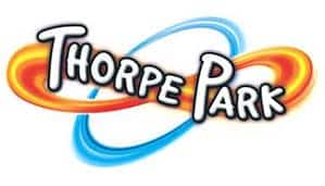 Thorpe Park logo with bold, white, cartoon-style letters outlined in black. Two colourful rings, one orange and one blue, loop behind the text, creating a sense of motion and excitement. The background is white.