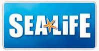 A blue rectangular logo with the word "SEA LIFE" in bold white uppercase letters. A small orange starfish replaces the middle line of the "A" in "SEA." The background has a gradient effect, transitioning from dark to light blue.
