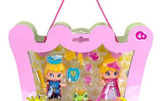 A pink crown-shaped Pinypon toy package with a handle, displaying two princess dolls, a green frog, and small accessories inside. The box features cartoon princess illustrations and is labelled for ages 4 and up.