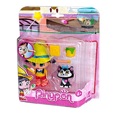 A packaged Pinypon toy set featuring a doll in a yellow hat and blue shoes, a small black-and-white cat figurine, a yellow square, a green cup, and a paint roller. The pink packaging includes brand art and is labelled for ages 4 and up.