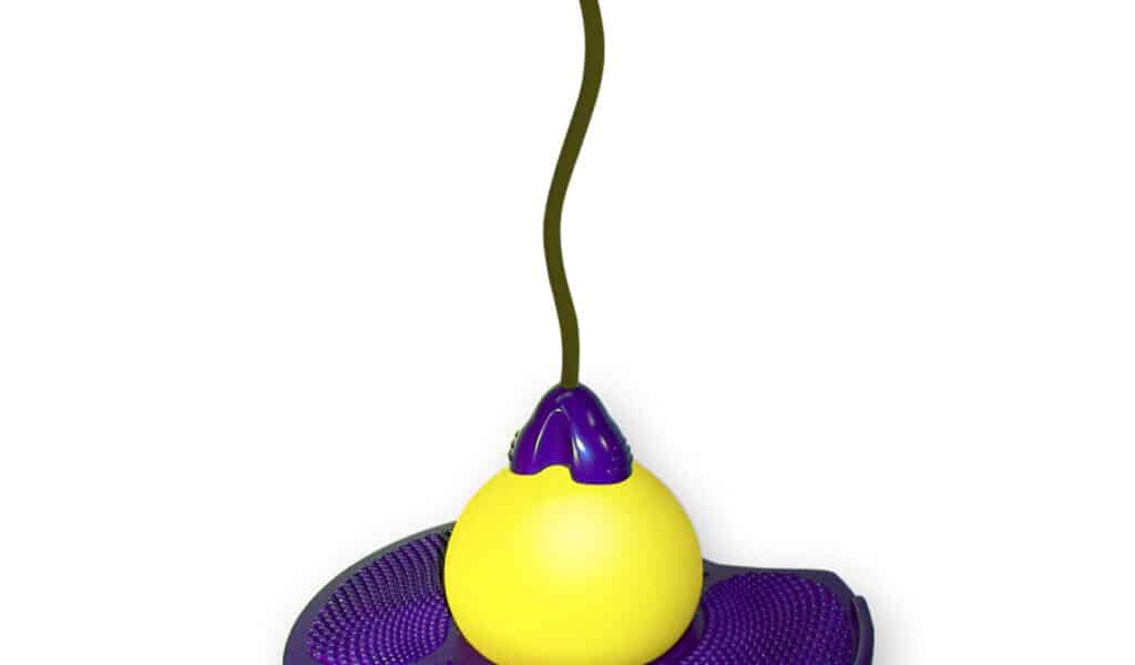 A yellow pogo ball toy with a purple circular platform in the centre, a handlebar at the top, and a cord connecting the handle to the ball, designed for jumping and balance activities.