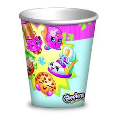 A colourful paper cup featuring cartoon Shopkins characters, including a strawberry, a biscuit, a shoe, and two other smiling, animated food items on a bright, playful background with stars and the Shopkins logo at the bottom.
