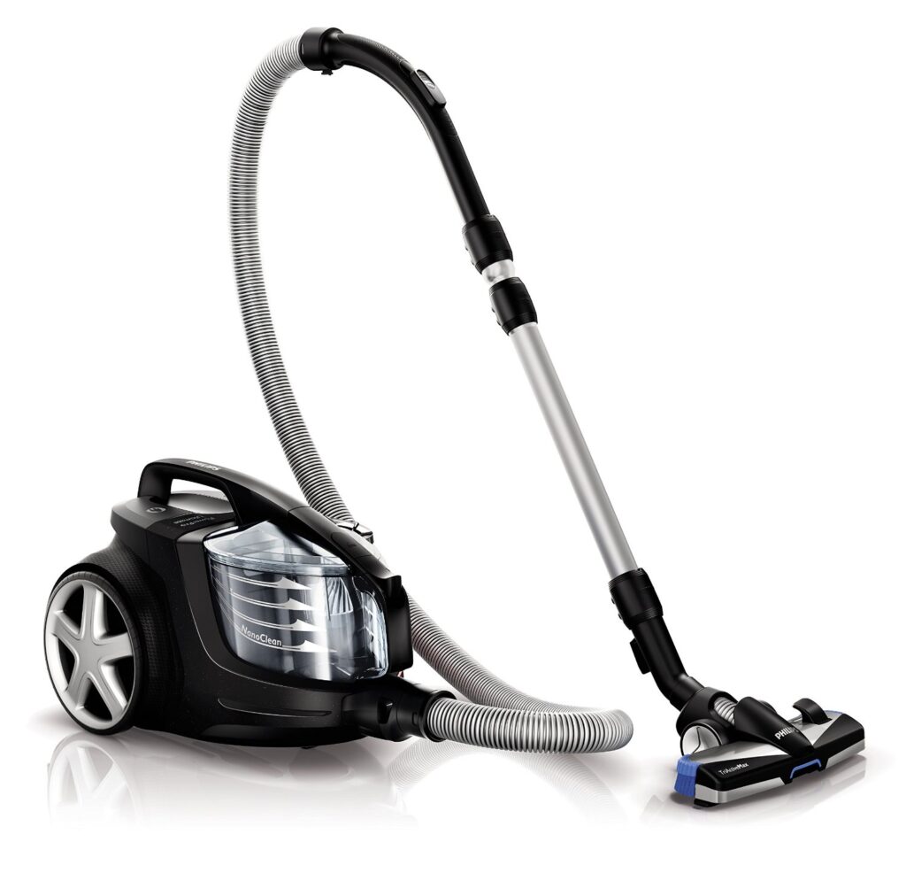 A modern black and silver canister vacuum cleaner with a transparent dust compartment, large rear wheels, a flexible hose, and a long silver extension tube attached to a wide floor brush. The vacuum is shown on a white background.