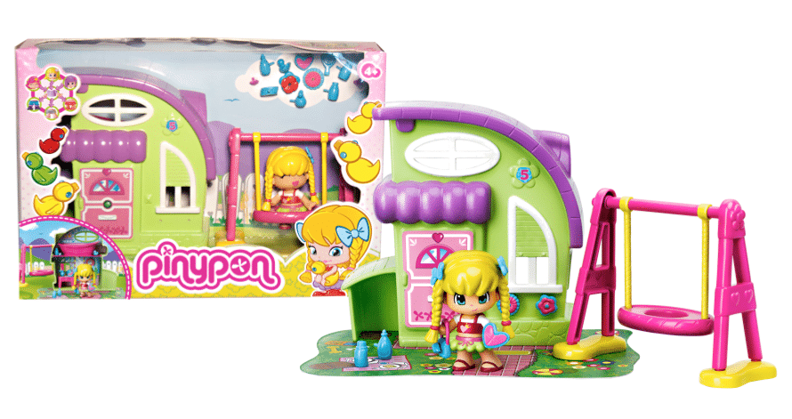 A colourful Pinypon playset with a green and purple doll’s house, a yellow-haired doll in pink clothes, a pink and yellow swing, and small toy accessories, shown next to its illustrated box featuring the same playset and character.
