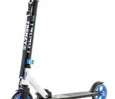 A black and white kick scooter with blue handlebars, blue wheels, and blue accents. The scooter is standing upright on its kickstand, and has the word “FRENZY” written vertically in white on the black stem.