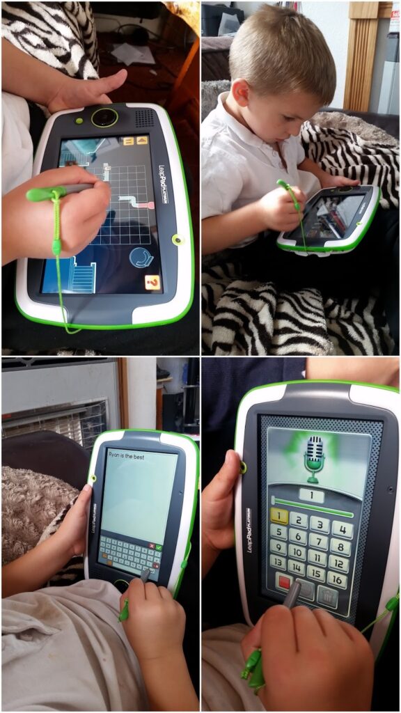 A young child uses a LeapFrog LeapPad with a green stylus, drawing on the screen, typing on a keyboard, and interacting with learning apps while seated on a sofa with zebra-patterned cushions in a well-lit room.