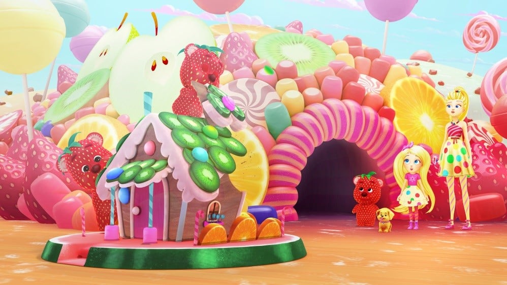 A colourful, sweet-themed landscape with giant lollipops, fruit slices, and a gingerbread house. Two girls, a dog, and strawberry characters stand in front, surrounded by bright sweets, a rainbow arch, and a whimsical, pastel sky.