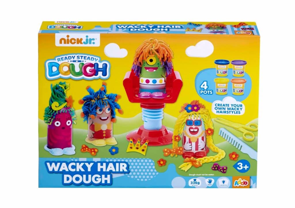 Colourful toy packaging for "Nick Jr. Ready Steady Dough: Wacky Hair Dough." The box shows three dough figures with playful, multicoloured hair, a red salon chair, dough pots, scissors, and styling accessories. For ages 3+; includes 4 dough pots.