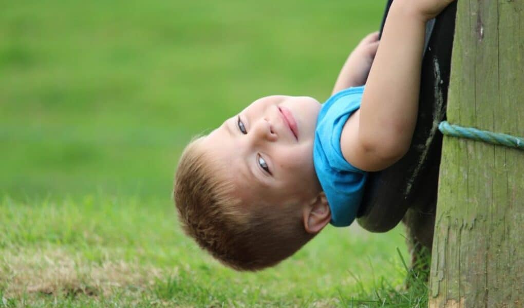 A child lying on a tyre.
