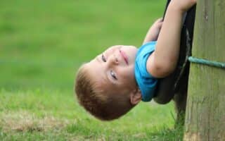 A child lying on a tyre.