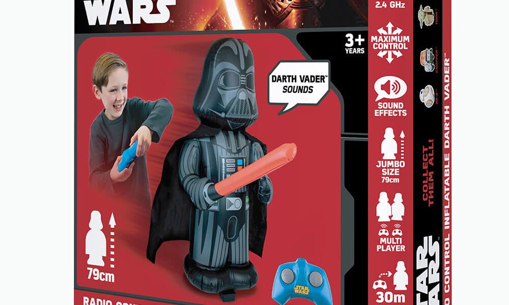 The image shows a Star Wars toy box featuring a remote control inflatable Darth Vader. A smiling boy plays with the toy using a blue remote. The box highlights features: Darth Vader sounds, jumbo size (79cm), 30m range, and 2.4 GHz control.
