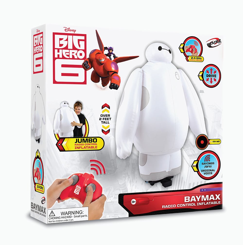 The image shows the packaging for a Disney "Big Hero 6" Baymax Radio Control Inflatable toy. The box features a large image of the inflatable Baymax, a red controller, logos, and information stating Baymax is over 2 feet tall and suitable for ages 3+.