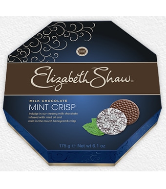Octagonal box of Elizabeth Shaw Mint Crisp Milk Chocolate. The dark blue packaging displays two chocolate discs, one partly unwrapped, with a mint leaf beside them. Text highlights the 175g weight and describes milk chocolate with mint oil and honeycomb crisp.