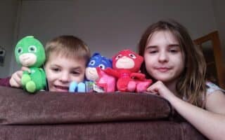 A boy and girl with soft toys.