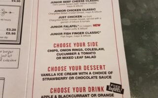 A restaurant junior menu priced at £3.95 offers a choice of burger, side, dessert, and drink. Options include beef or chicken burgers, fish fingers, or falafel, with sides like chips or salad, and a dessert of ice cream. Drink options are juice, milk, water, or mini milkshake.