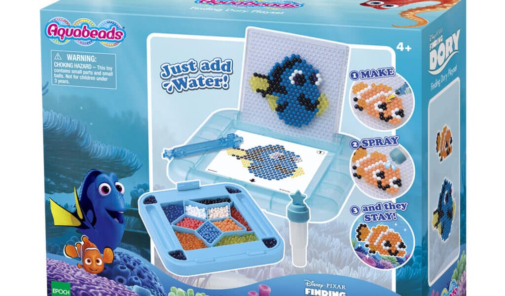 A box of Aquabeads Finding Dory Playset features Dory, Nemo, and other sea creatures made from colourful water-fused beads. The packaging shows finished bead designs, included tools, and the slogan “Just add water!” with images of the characters underwater.