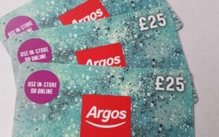 Three Argos £25 gift cards are fanned out on a white surface. The cards have a turquoise, glittery pattern with the Argos logo, “GIFT CARD,” and a purple sticker reading “USE IN-STORE OR ONLINE”.