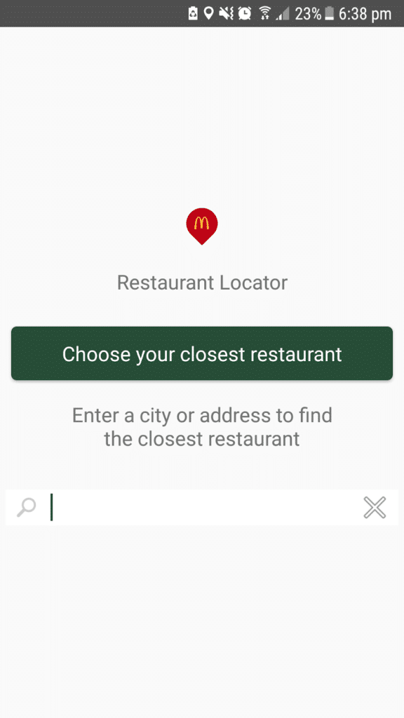 Screenshot of a McDonald’s Restaurant Locator app. A red McDonald's icon is above the text “Restaurant Locator.” A green button says, “Choose your nearest restaurant.” Below, a search bar prompts users to enter a city or address. Status bar shows 23% battery.
