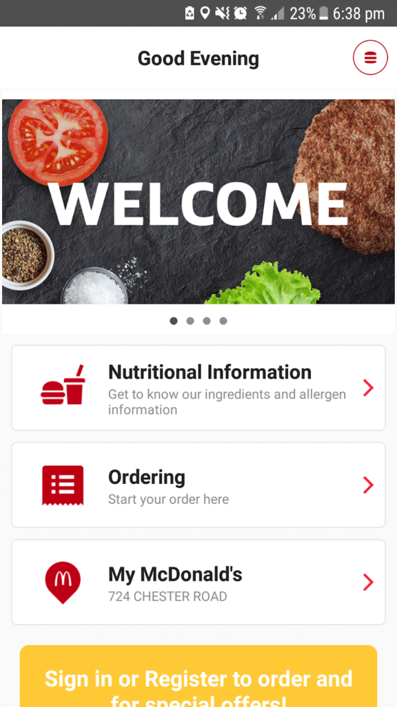 A mobile app screen displays a greeting "Good Evening" and the word "WELCOME" over an image of a tomato slice, burger patty, lettuce, salt, and pepper. Menu options include Nutritional Information, Ordering, and My McDonald's at 724 Chester Road.