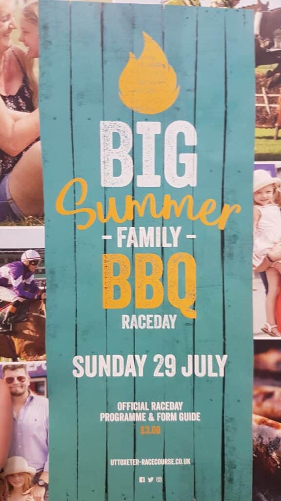 A colourful event poster reads: “Big Summer Family BBQ Raceday, Sunday 29 July.” The design features a yellow flame and white and orange text on a teal background. Additional info states: “Official raceday programme & form guide £3.00. uttoxeter-racecourse.co.uk.”.