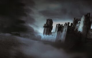 A large, old stone castle with round towers stands on a foggy, grassy hill under a dark, stormy sky. The scene is dimly lit, creating a mysterious and eerie atmosphere. Thick mist partially obscures the ground and much of the structure.