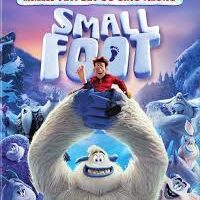 Blu-ray cover for "Smallfoot." A big, white yeti holds a smiling human man in red on its hand. Other yetis stand behind them on a snowy mountain. The title "SMALLFOOT" is in large white letters, and a banner above mentions a "Yeti Set Go Sing-Along.