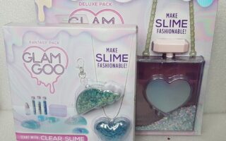 A box with a bottle and a necklace.