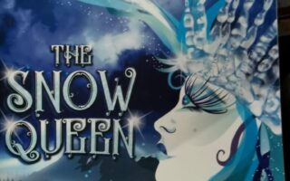 A theatre programme cover for "The Snow Queen" shows a profile of a white-faced woman with icy blue features and a crystal crown. Above her, two silhouetted figures stand on a curved icy path against a large moon and snowy sky.