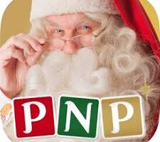 A man dressed as Father Christmas with white hair, a curly beard, and spectacles, holds his spectacles while looking forward. Three coloured blocks at the bottom display the letters "PNP" in red, green, and gold.