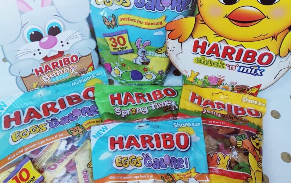A variety of colourful HARIBO Easter-themed sweet bags are displayed, featuring “Eggs Galore,” “Bunny,” “Spring Time,” and “Chick ‘n’ Mix.” The packaging includes cartoon bunnies and chicks on a white background with gold polka dots.
