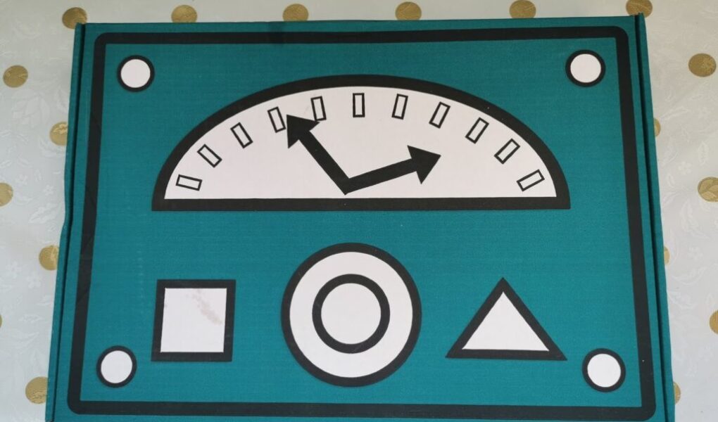 A stylised control panel with a teal background features a large semicircular gauge with two black arrows pointing left and up. Below it are three shapes: a square, a circle, and a triangle. The panel has four round bolts at the corners.