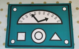 A stylised control panel with a teal background features a large semicircular gauge with two black arrows pointing left and up. Below it are three shapes: a square, a circle, and a triangle. The panel has four round bolts at the corners.