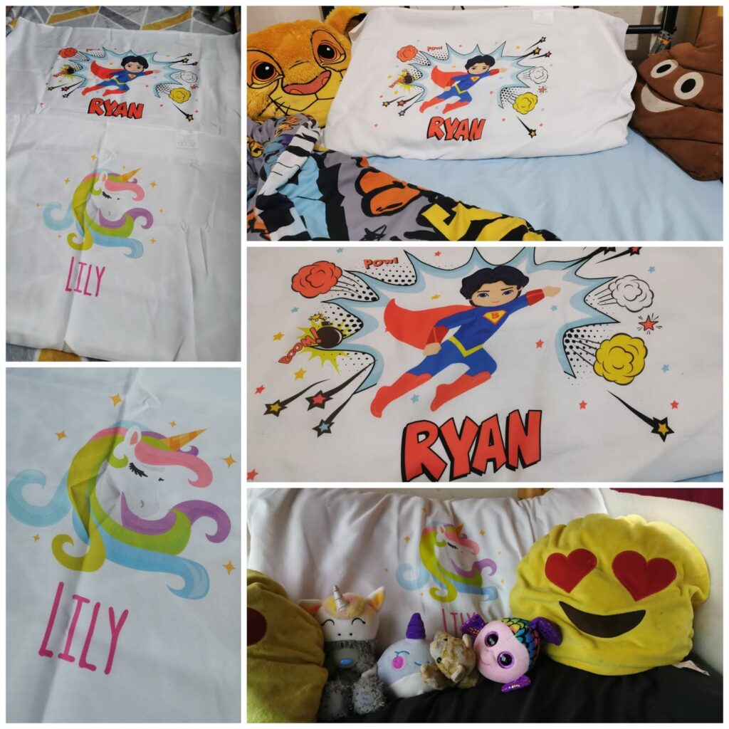 A collage shows two personalised pillowcases: one with a superhero labelled "RYAN" with comic-style stars, and another with a unicorn labelled "LILY." Both are on beds with soft toys, including a lion, bear, unicorn, and emoji face with heart eyes.
