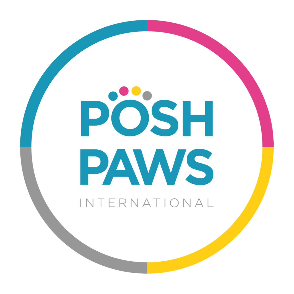 A circular logo with "POSH PAWS INTERNATIONAL" in blue and grey text. Four colourful dots above "O" resemble a paw print. The circle’s border has magenta, yellow, blue, and grey segments on a white background.