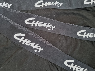 A group of black wristbands with white writing on them.