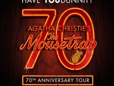 A poster with glowing red and orange text reads: "Have YOU dunnit? 70 Agatha Christie's The Mousetrap 70th Anniversary Tour." The number 70 and "The Mousetrap" are in neon-style script, with a small mouse illustration on the "p.