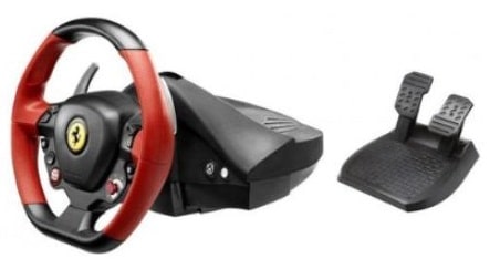 A black and red gaming steering wheel with Ferrari logo and buttons, shown alongside a separate black set of two foot pedals for acceleration and braking, both placed on a white background.