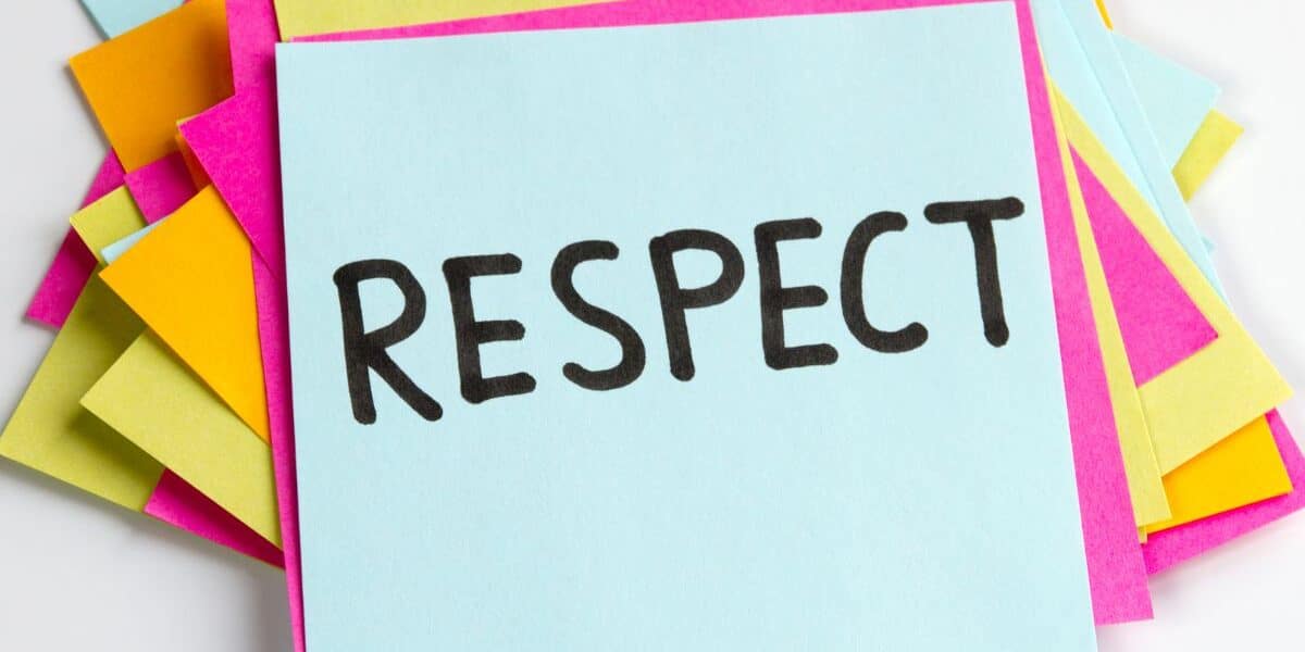 A stack of colourful sticky notes, with a blue note on top displaying the word "RESPECT" written in bold, black letters. The notes beneath are pink, yellow, and orange, creating a vibrant and positive background.